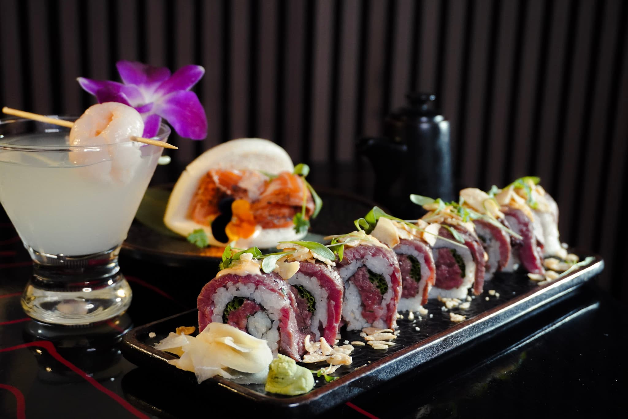 Beef sushi roll with cocktails and bao.
